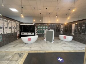 Coventry bathroom showroom display featuring freestanding baths, designer shower fittings, and wall-mounted shower systems from leading brands.